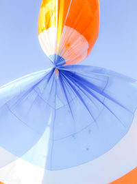Low angle view of airplane flying against blue sky