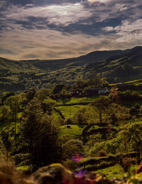 Scenic view of field against cloudy sky