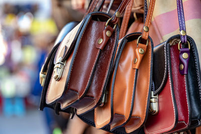 Close-up of sling bags for sale at market