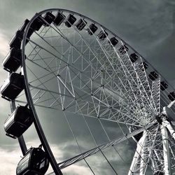 Low angle view of ferris wheel against sky