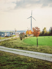 Windmill on field against sky