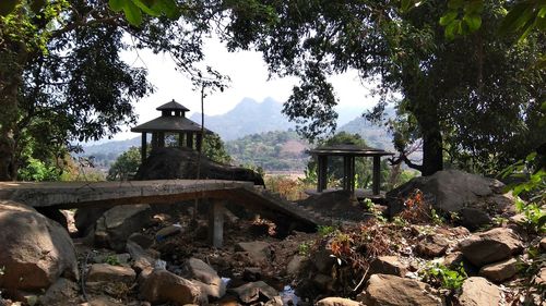 Gazebo by trees against sky