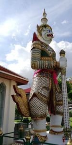Low angle view of statue against temple building