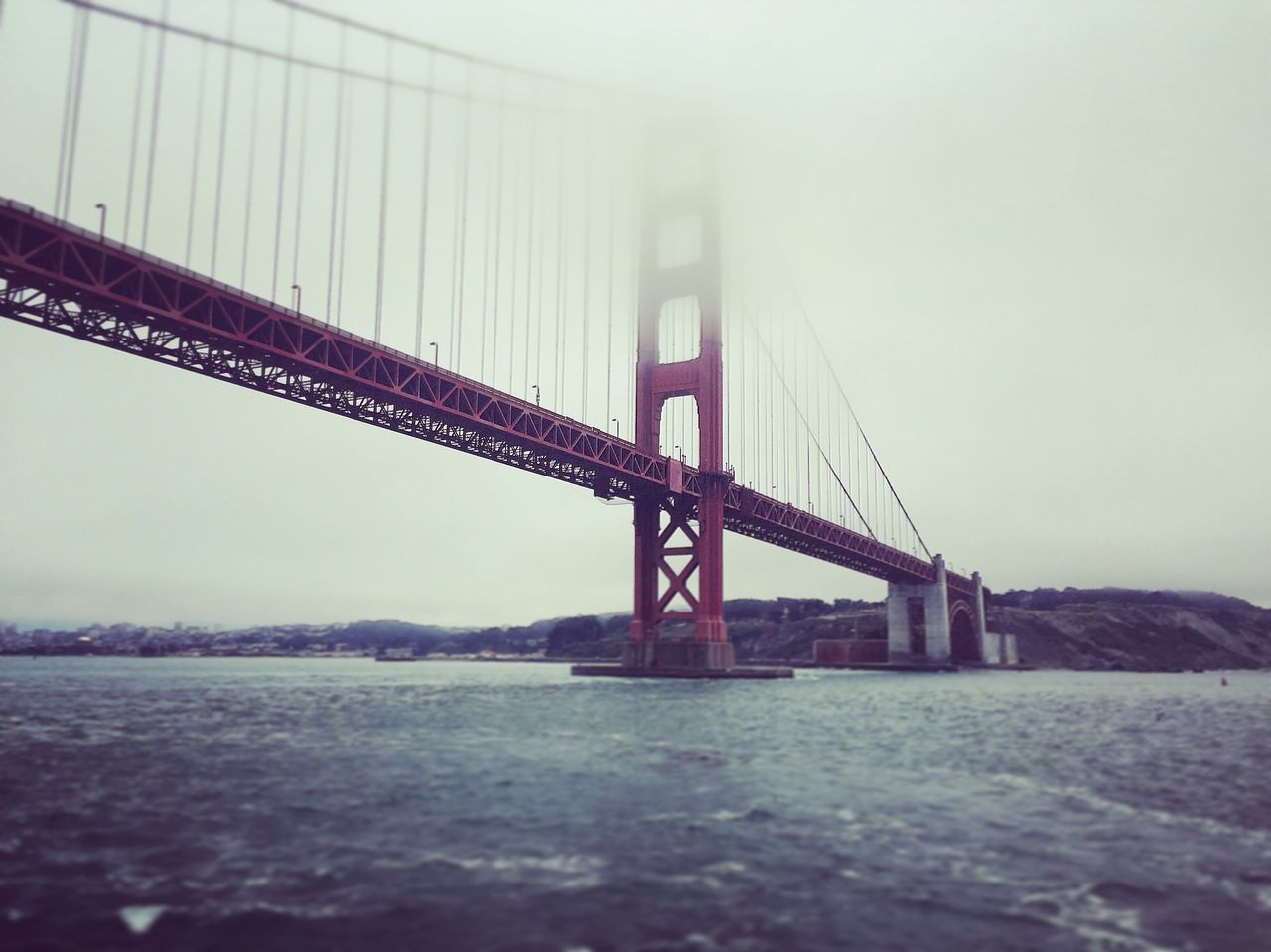 built structure, architecture, connection, bridge - man made structure, engineering, suspension bridge, water, waterfront, river, fog, bridge, sky, travel destinations, foggy, weather, day, outdoors, no people, tourism, nature, capital cities, development, overcast, tranquility