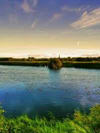 View of calm lake against cloudy sky