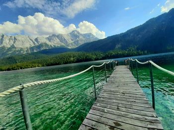 Pier over lake against mountains