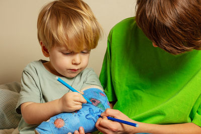 Close-up of girl drawing at home