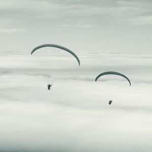 Person paragliding against sky