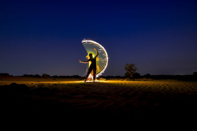 Man standing on field against clear sky