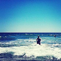 Scenic view of sea against blue sky