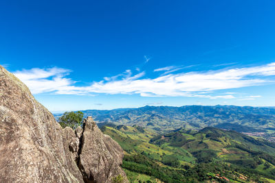 Scenic view of mountains against blue sky