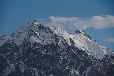 Low angle view of snowcapped mountain against sky