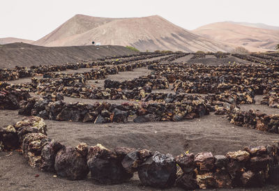 Stones arranged on land against mountain