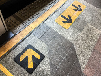 High angle view of arrow sign on road