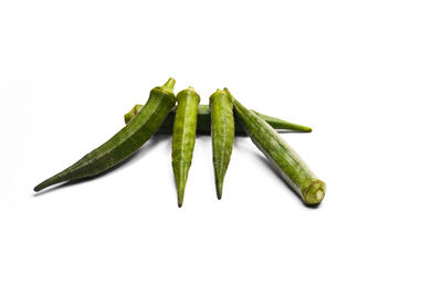 Close-up of green chili pepper against white background