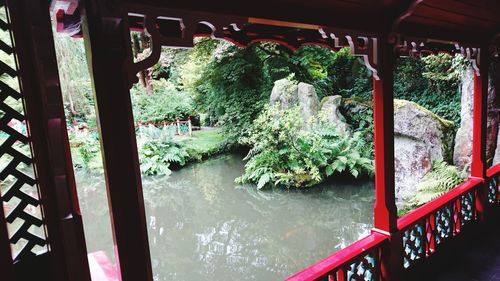 Bridge over river against trees