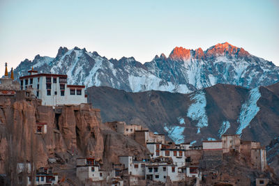 Buildings in city against clear sky