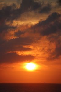 Scenic view of sea against romantic sky at sunset