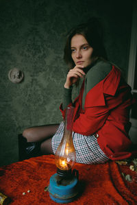 Portrait of young woman sitting at home