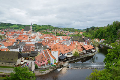 High angle view of townscape by river against sky