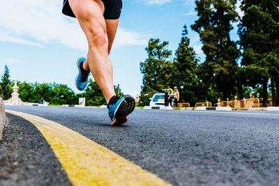 Low section of man running on road