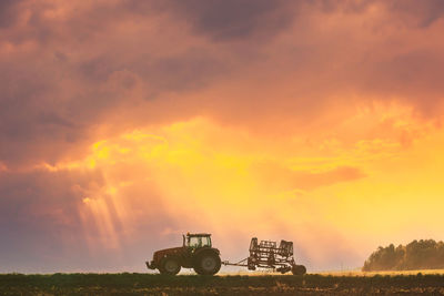 Scenic view of field against sky during sunset