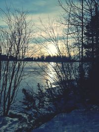 Scenic view of lake against sky during winter