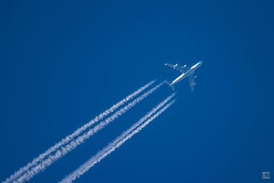 Low angle view of airplane flying in sky