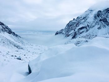 Scenic view of snow covered mountains against sky