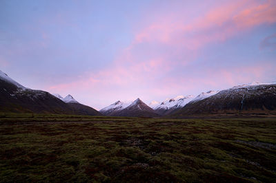 Scenic view of snowcapped mountains against sky during sunset