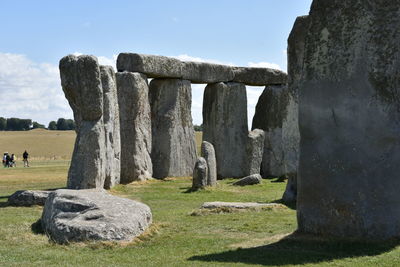 Stone structure on field against sky