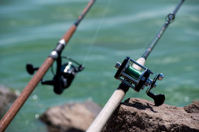 High angle view of fishing rod by lake