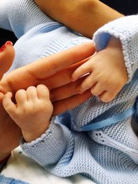 Close-up of hands holding baby