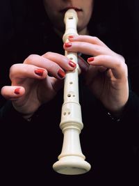 Close-up of woman playing flute