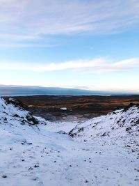 Scenic view of snowcapped mountains against sky