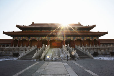 Fountain in temple building against sky