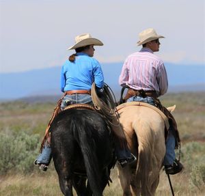 Rear view of man riding horse