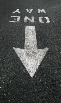 High angle view of arrow symbol on road in city