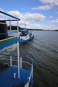 Boat sailing in sea against sky