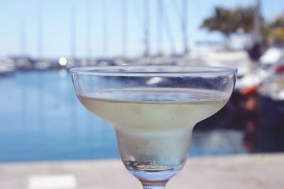 Close-up of drink at harbor against sky