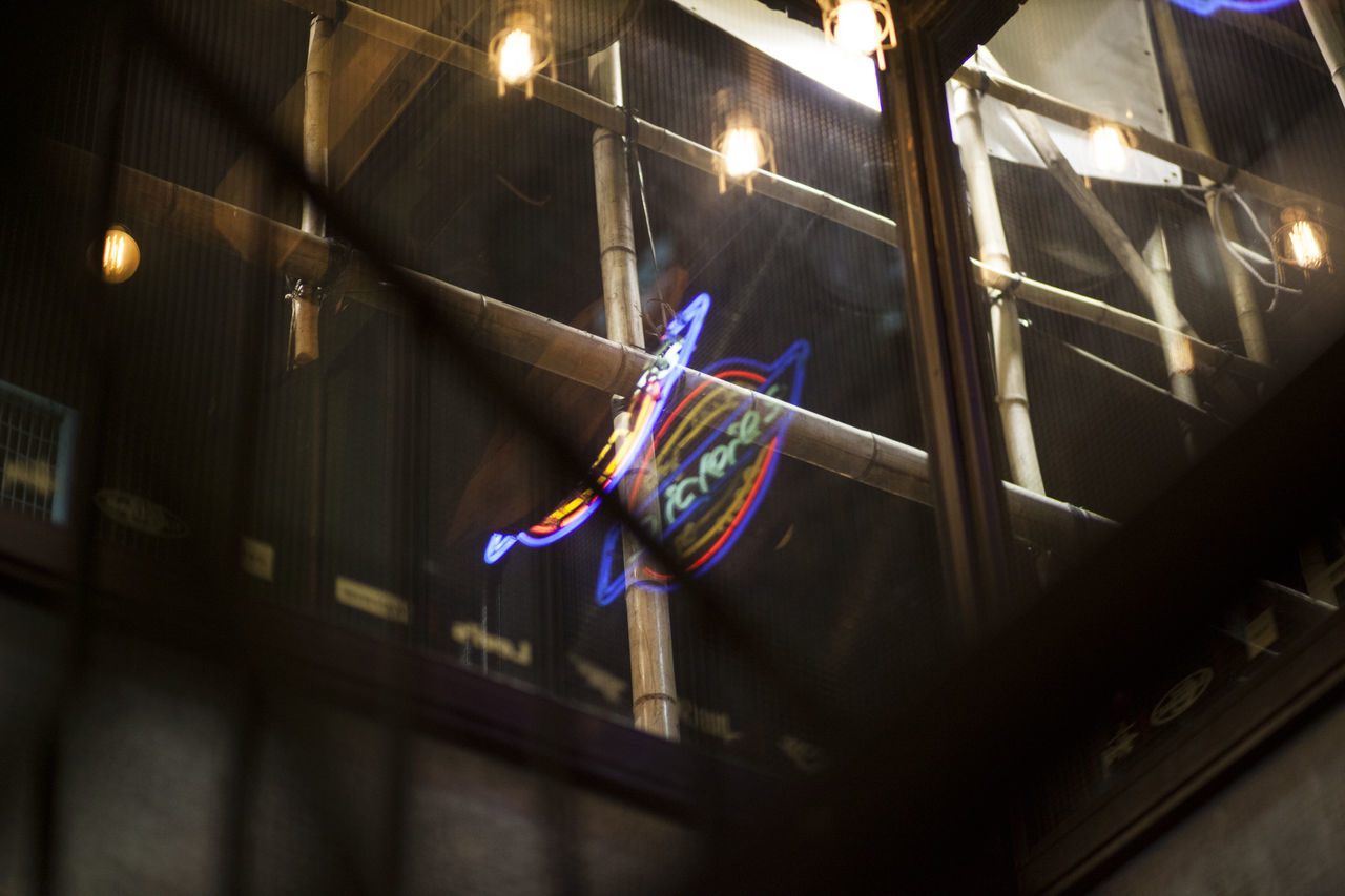 LOW ANGLE VIEW OF FLAGS HANGING IN ILLUMINATED LIGHTS