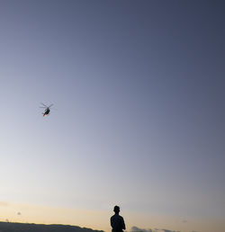 Low angle view of airplane flying against clear sky