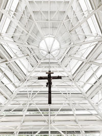 Low angle view of man standing on ceiling
