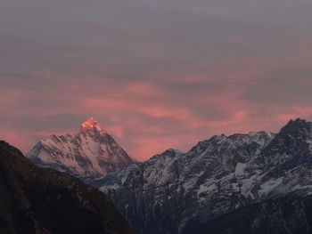 A pink sunset over nanda devi peak visible from auli