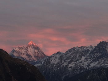 Scenic view of snowcapped mountains against sky during sunset