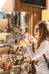 Woman buying bracelets at shop