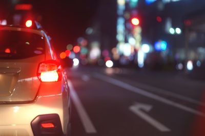 Close-up of car on road at night