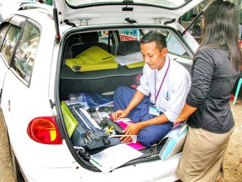 Full length of men standing in car