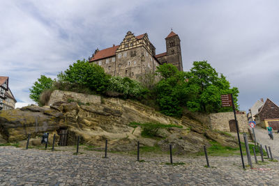 Trees and buildings against sky