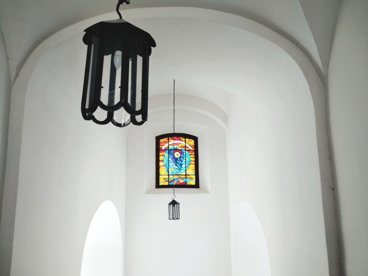 indoors, architecture, no people, arch, belief, built structure, religion, spirituality, place of worship, hanging, building, wall - building feature, day, white color, lighting equipment, ceiling, window, glass, electric lamp